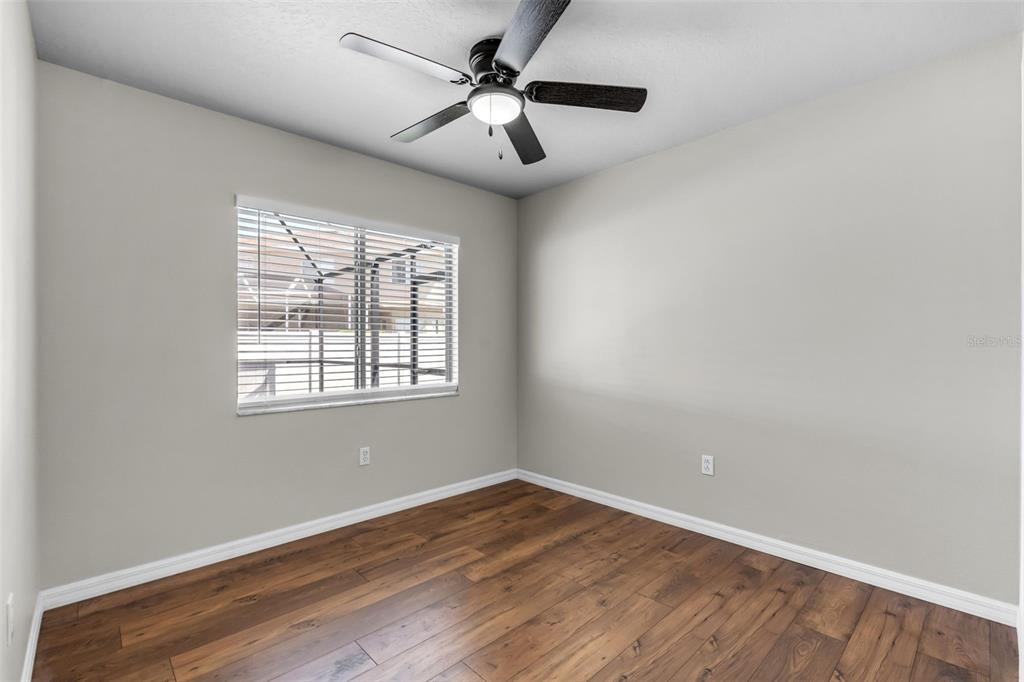 1424 Ocean Reef Road Wesley Chapel, FL 33544 - Photo 21 of 47 wooden floor in an empty room with a window