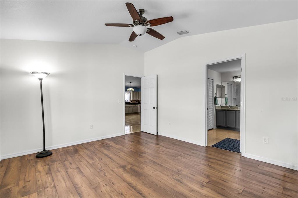 1424 Ocean Reef Road Wesley Chapel, FL 33544 - Photo 24 of 47 a view of empty room with wooden floor and fan