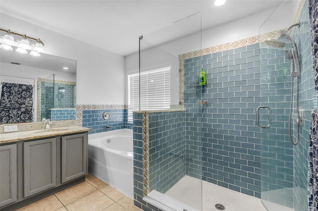 1424 Ocean Reef Road Wesley Chapel, FL 33544 - Photo 26 of 47 a bathroom with a sink and mirror with bathtub