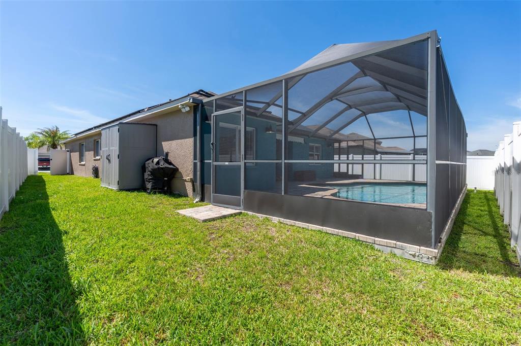 1424 Ocean Reef Road Wesley Chapel, FL 33544 - Photo 36 of 47 a view of a backyard with sitting area and garden