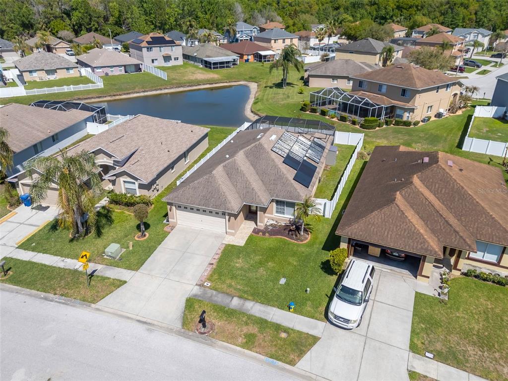 1424 Ocean Reef Road Wesley Chapel, FL 33544 - Photo 38 of 47 an aerial view of a house with a garden and lake view