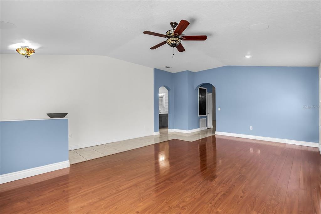 1424 Ocean Reef Road Wesley Chapel, FL 33544 - Photo 5 of 47 a view of a room with wooden floor and ceiling fan