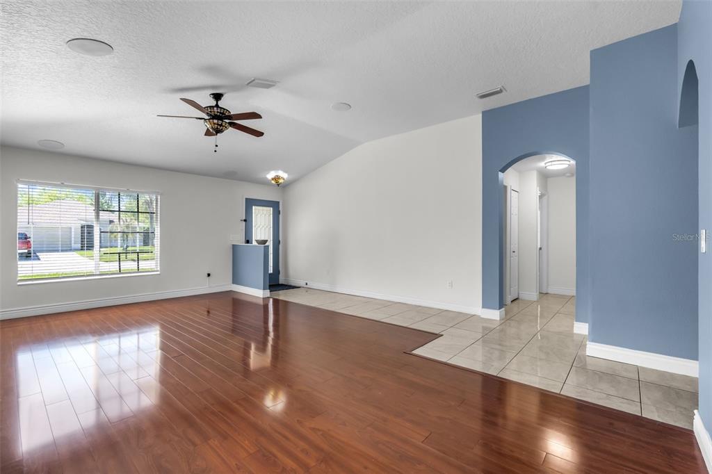 1424 Ocean Reef Road Wesley Chapel, FL 33544 - Photo 6 of 47 a view of empty room with wooden floor and fan
