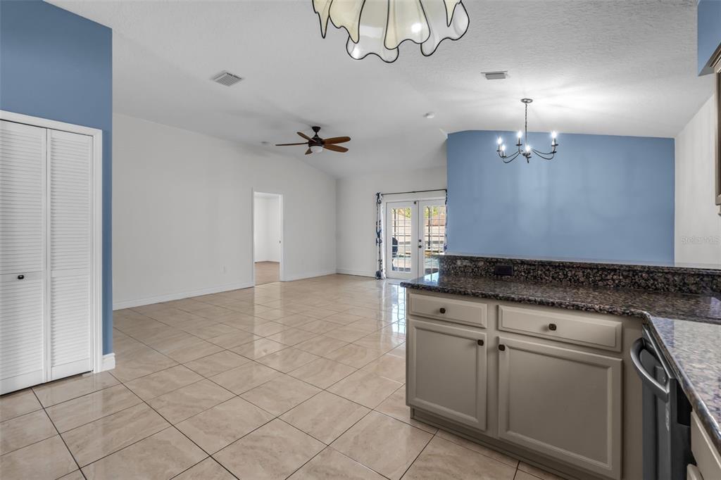 1424 Ocean Reef Road Wesley Chapel, FL 33544 - Photo 9 of 47 a view of a kitchen with furniture and chandelier fan
