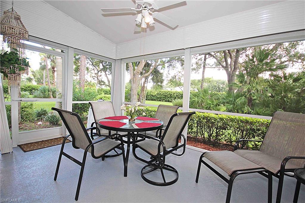 322 Melrose Place, Unit 31 Naples, FL 34104 - Photo 13 of 18 a view of a dining room with furniture window and wooden floor