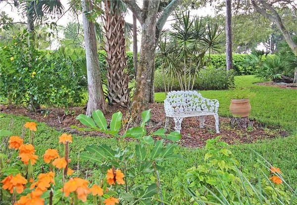 a view of a table and chairs in a garden