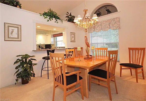 a view of a dining room with furniture and a chandelier