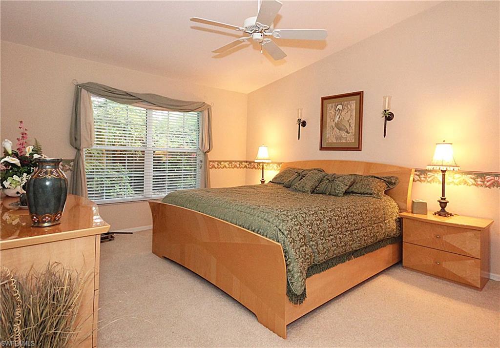 322 Melrose Place, Unit 31 Naples, FL 34104 - Photo 8 of 18 a bedroom with a bed dresser and a window