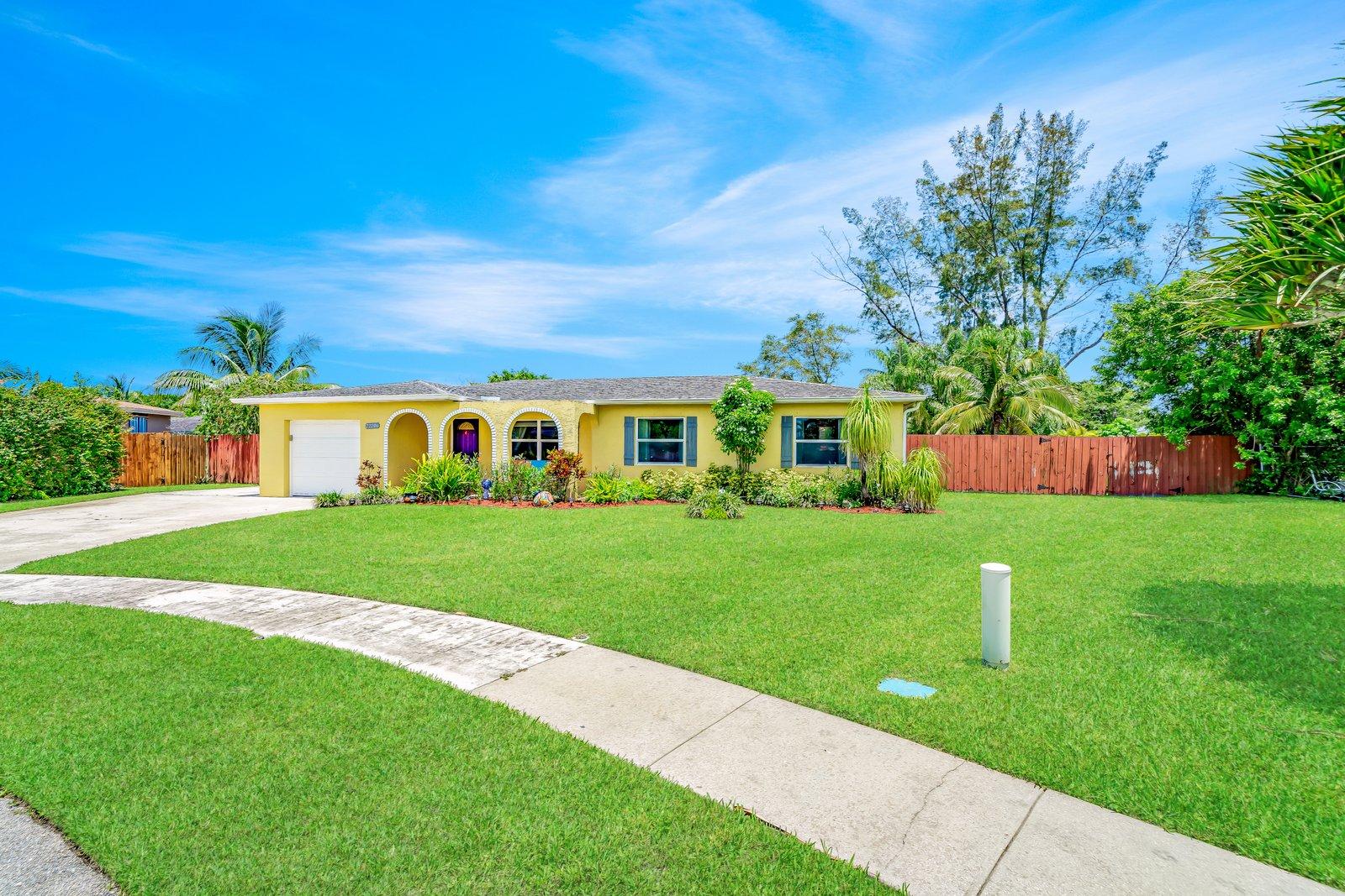 22206 Aquila Street Boca Raton, FL 33428 - Photo 11 of 73 a front view of a house with a yard