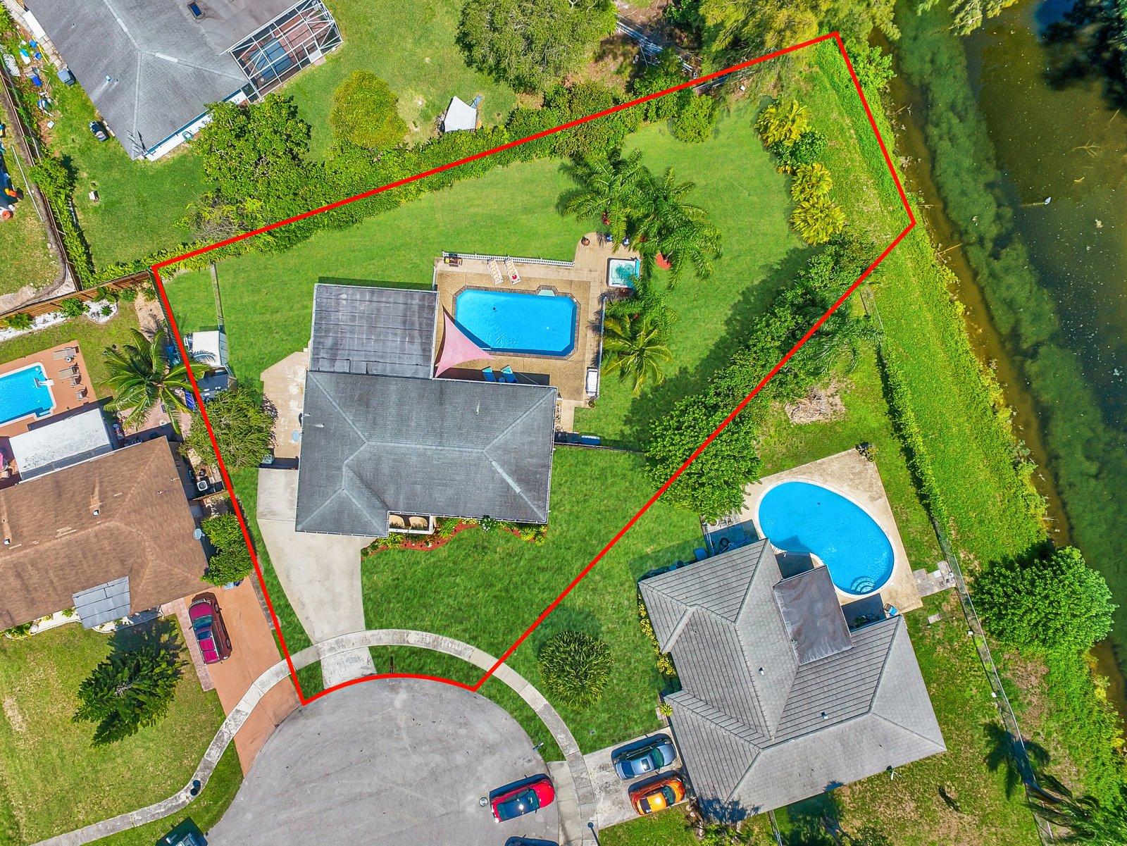 22206 Aquila Street Boca Raton, FL 33428 - Photo 2 of 73 an aerial view of a house with a yard and tennis court