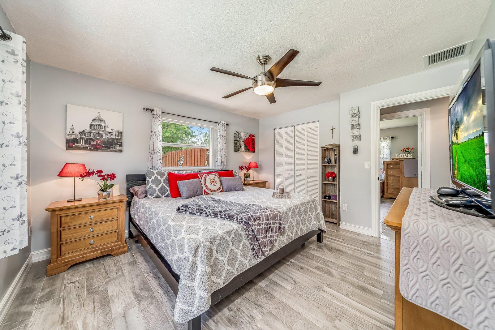 22206 Aquila Street Boca Raton, FL 33428 - Photo 32 of 73 a bedroom with a bed and wooden floor