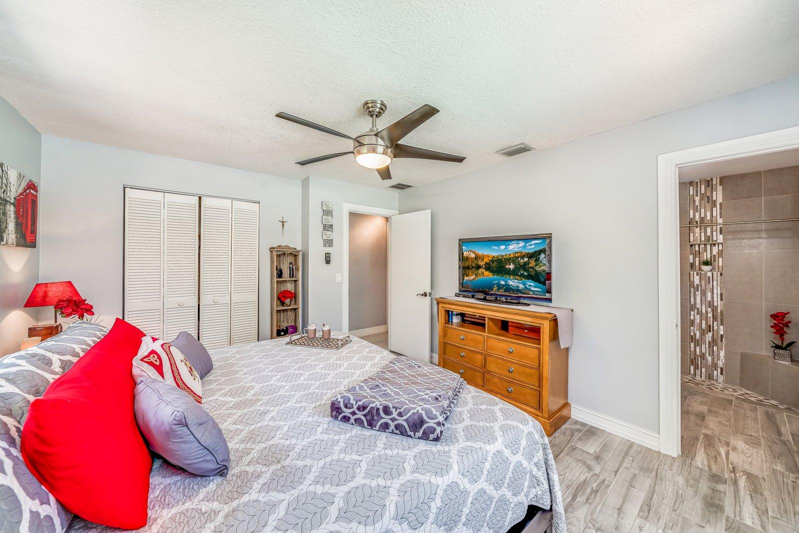 22206 Aquila Street Boca Raton, FL 33428 - Photo 33 of 73 a bedroom with a bed and a chandelier