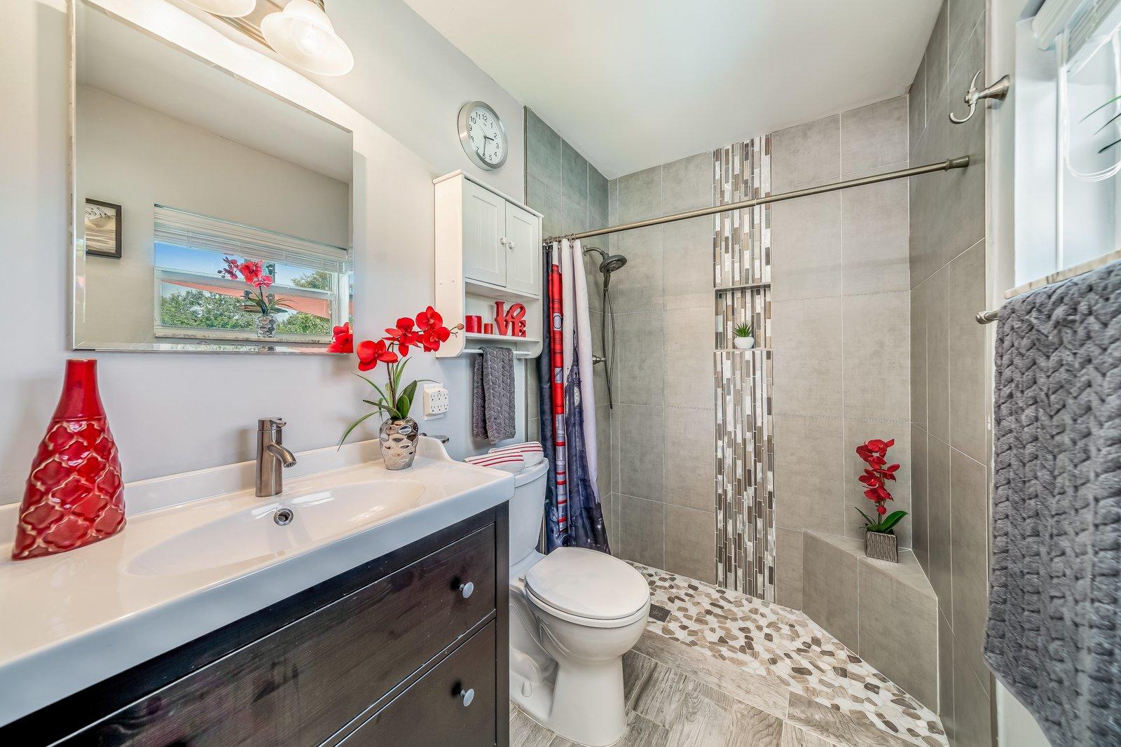 22206 Aquila Street Boca Raton, FL 33428 - Photo 34 of 73 a bathroom with a sink toilet and shower