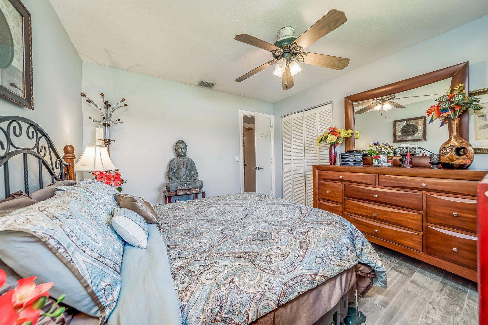 22206 Aquila Street Boca Raton, FL 33428 - Photo 36 of 73 a bedroom with a bed and dresser with mirror