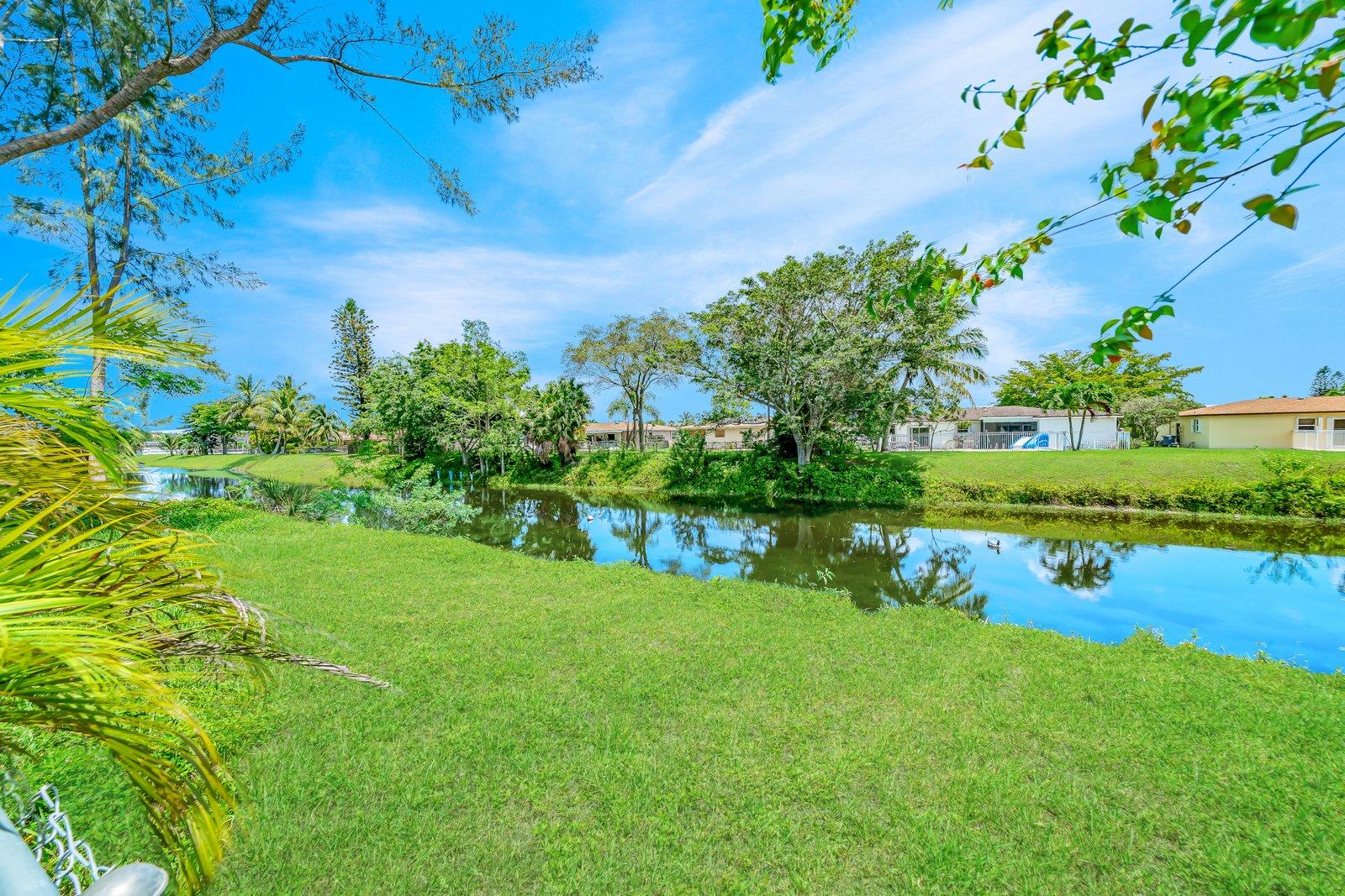 22206 Aquila Street Boca Raton, FL 33428 - Photo 7 of 73 a view of a garden with plants and large trees