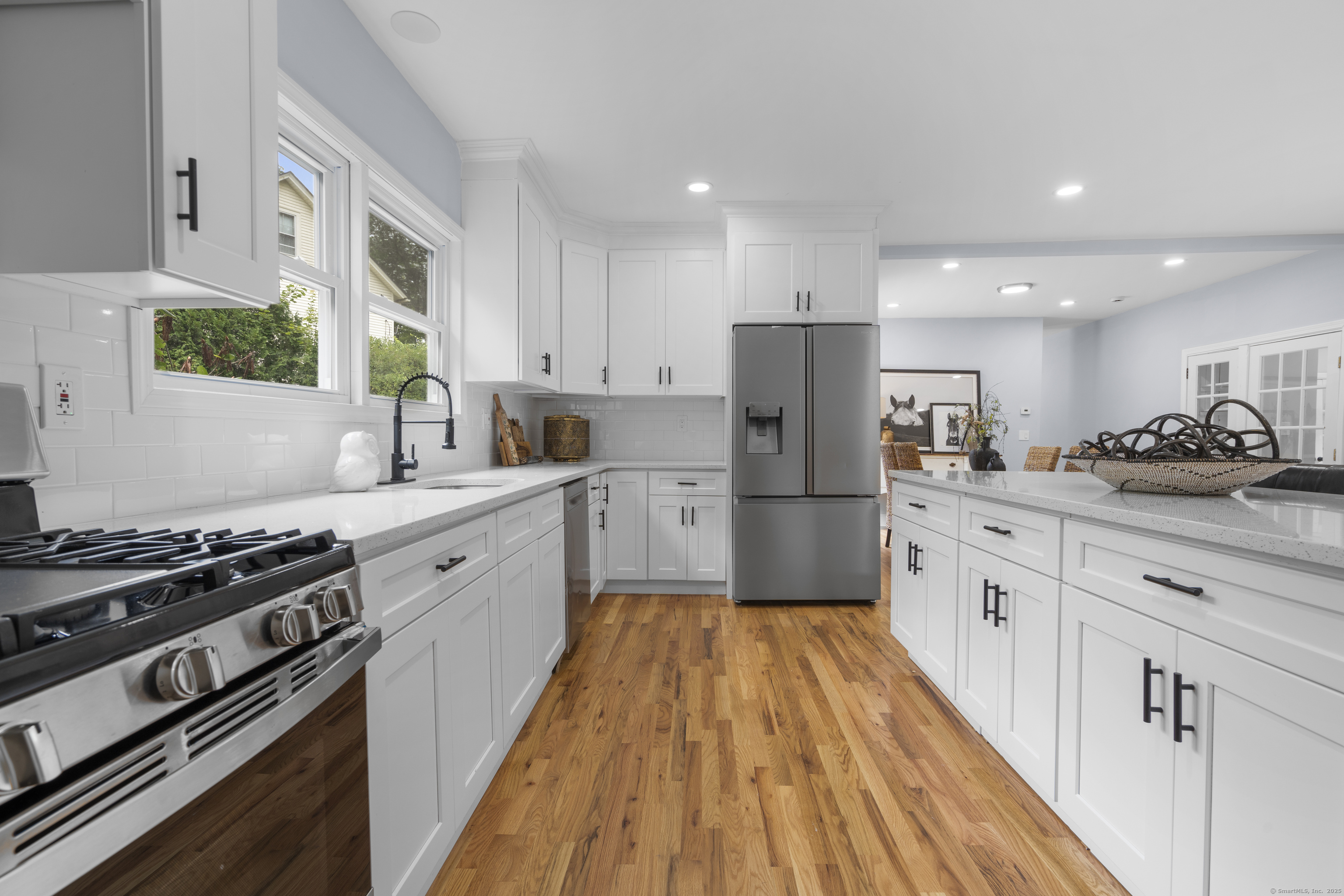a kitchen with stainless steel appliances a refrigerator sink and cabinets