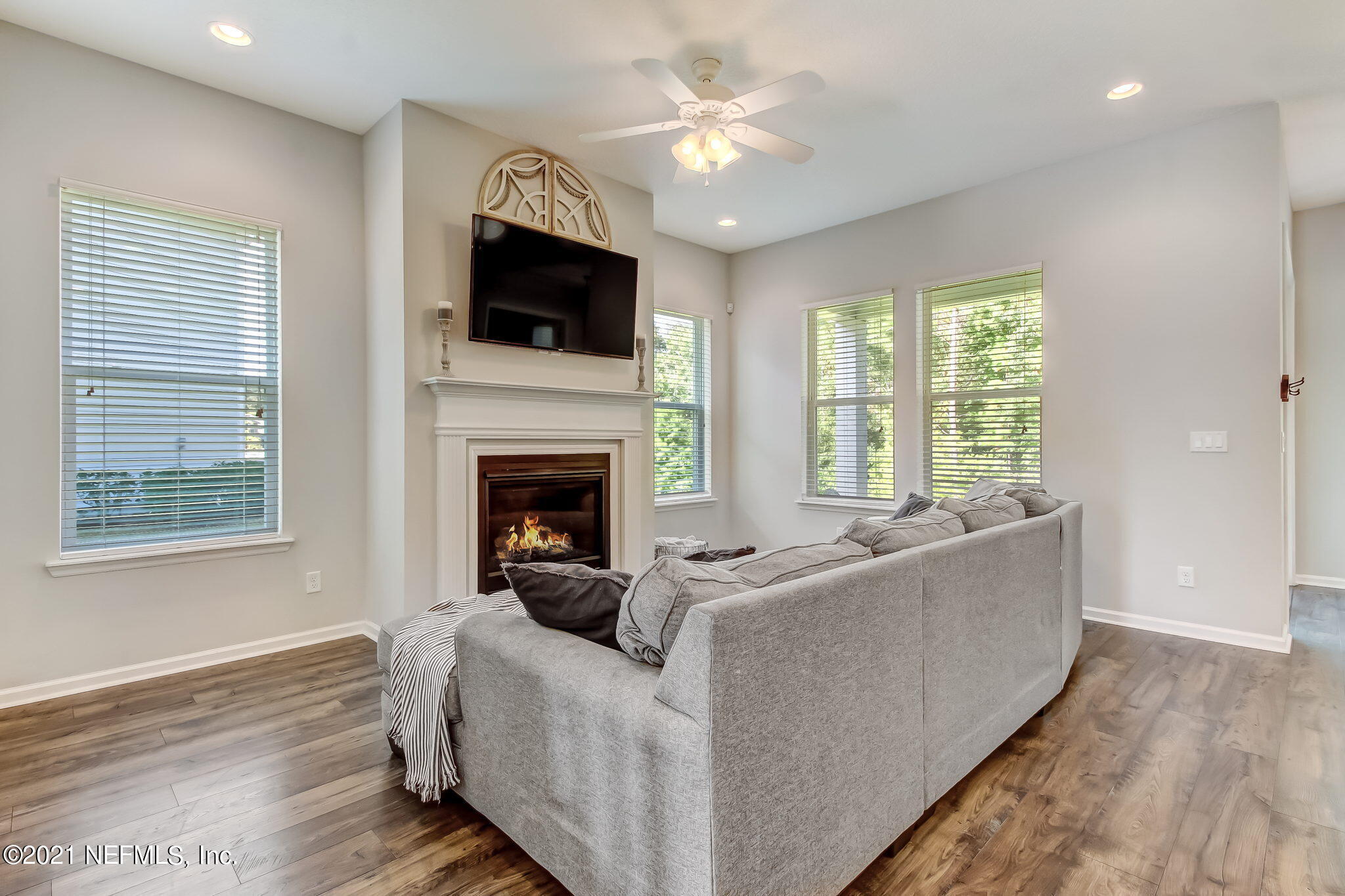 33 Adler Place St. Johns, FL 32259 - Photo 19 of 82 a living room with furniture a fireplace and a flat screen tv