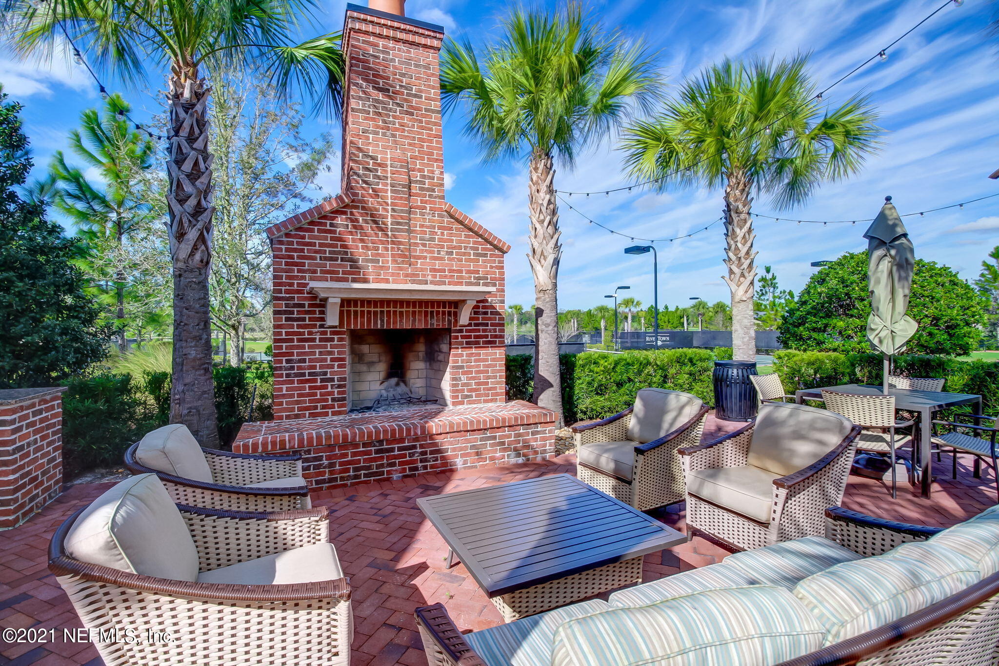 33 Adler Place St. Johns, FL 32259 - Photo 51 of 82 a view of a patio with couches table and chairs potted plants and palm tree
