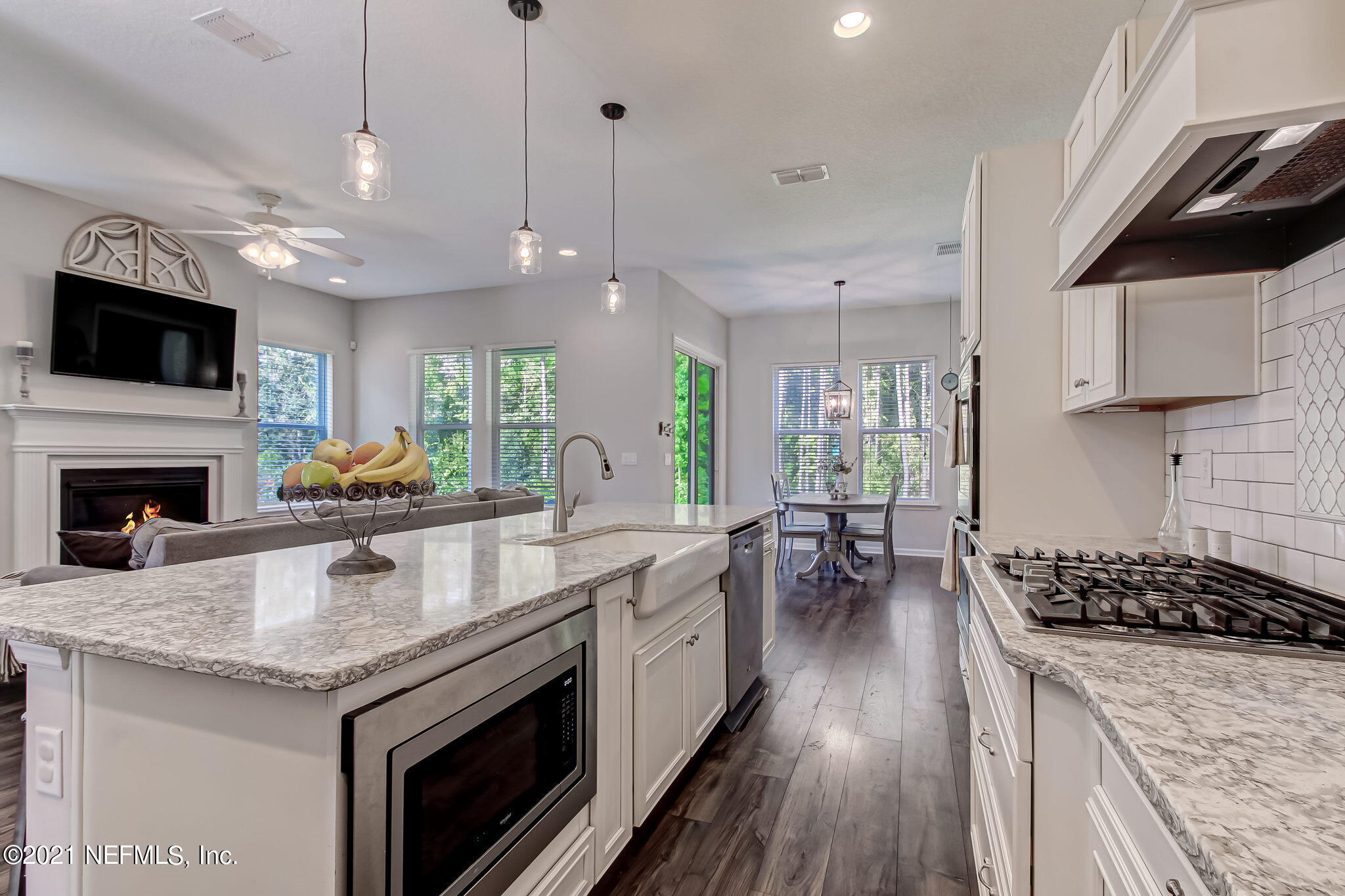 33 Adler Place St. Johns, FL 32259 - Photo 8 of 82 a open kitchen with granite countertop a stove top oven a sink a counter space and wooden floor