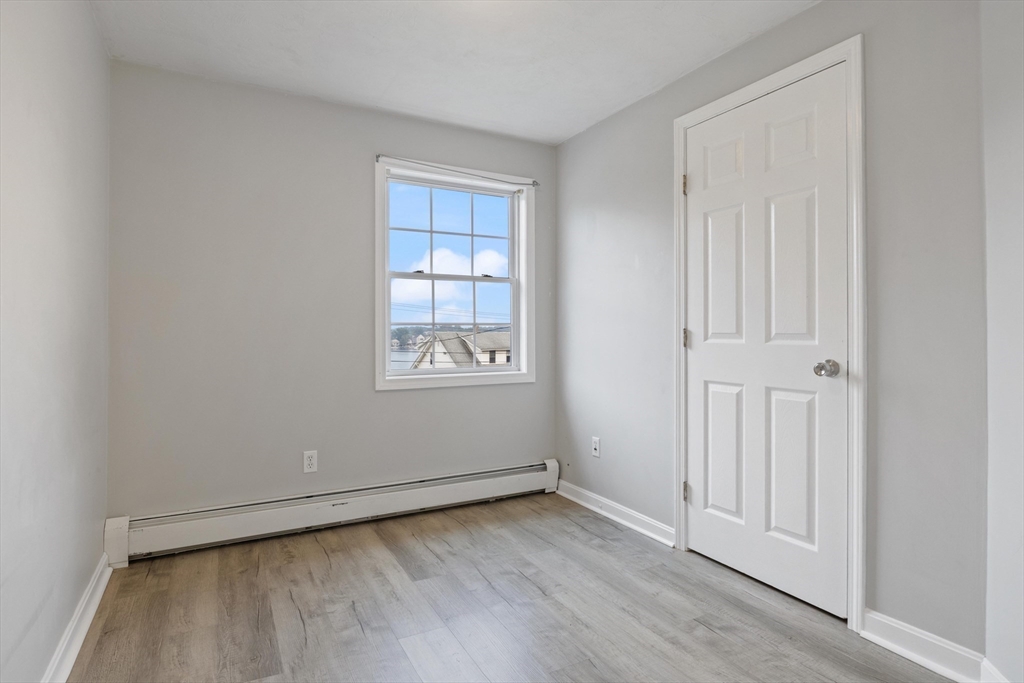 442 Lake Avenue Worcester, MA 01604 - Photo 9 of 14 an empty room with wooden floor and windows