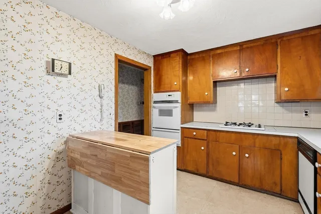 a kitchen with stainless steel appliances a stove refrigerator sink and cabinets