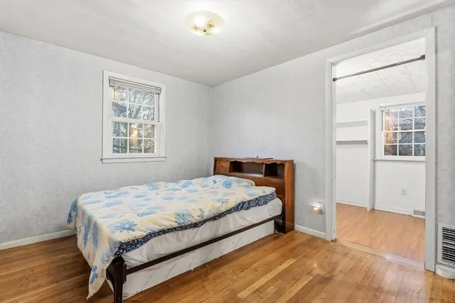 a bedroom with a bed lamp and a window