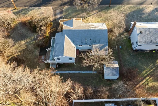 a view of a house with a yard and wooden fence