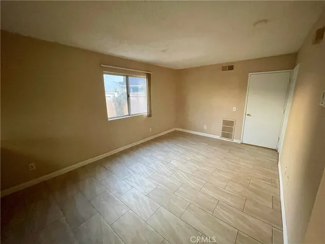 a bathroom with a granite countertop toilet and a sink