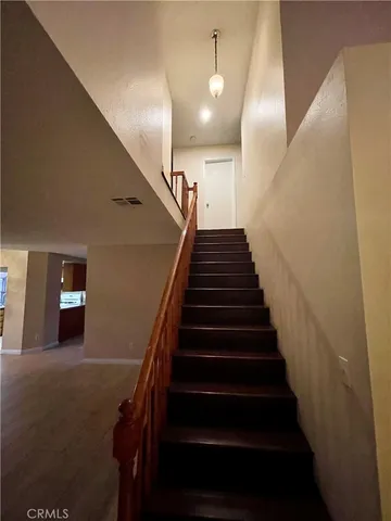 a view of entryway with stairs and wooden floor