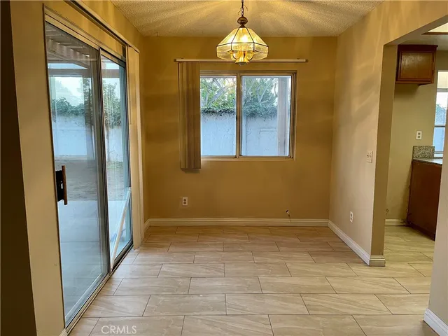 an empty room with wooden floor and door