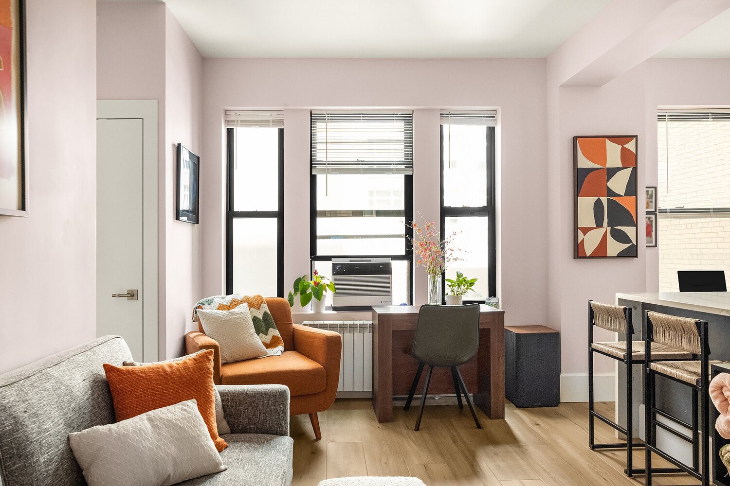 215 West 75th Street, Unit 9E Manhattan, NY 10023 - Photo 4 of 10 a living room with furniture and large windows