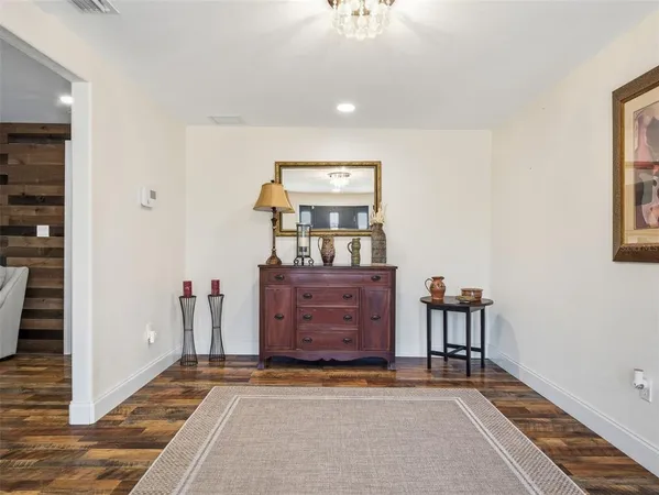 a view of room with window and wooden floor