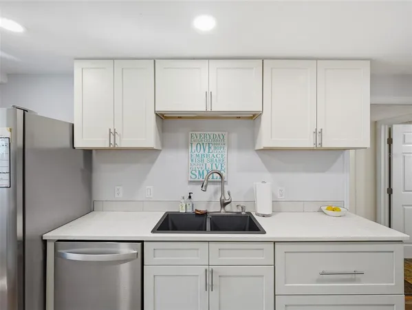 a kitchen with cabinets appliances and a sink