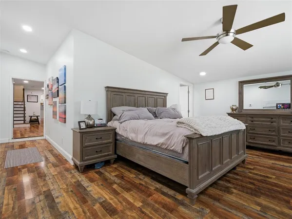 a bedroom with a bed and ceiling fan