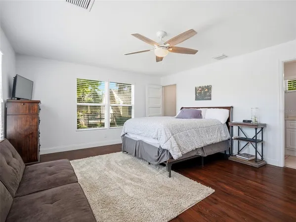 a spacious bedroom with a bed and a walk in closet