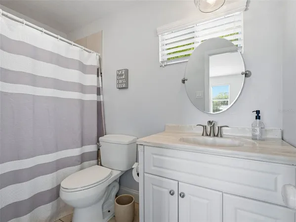 a bed sitting in a spacious bedroom next to a window