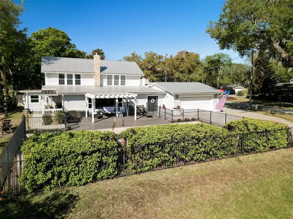 a view of a house with a chairs in a patio