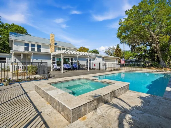 an aerial view of a house with a yard basket ball court and outdoor seating