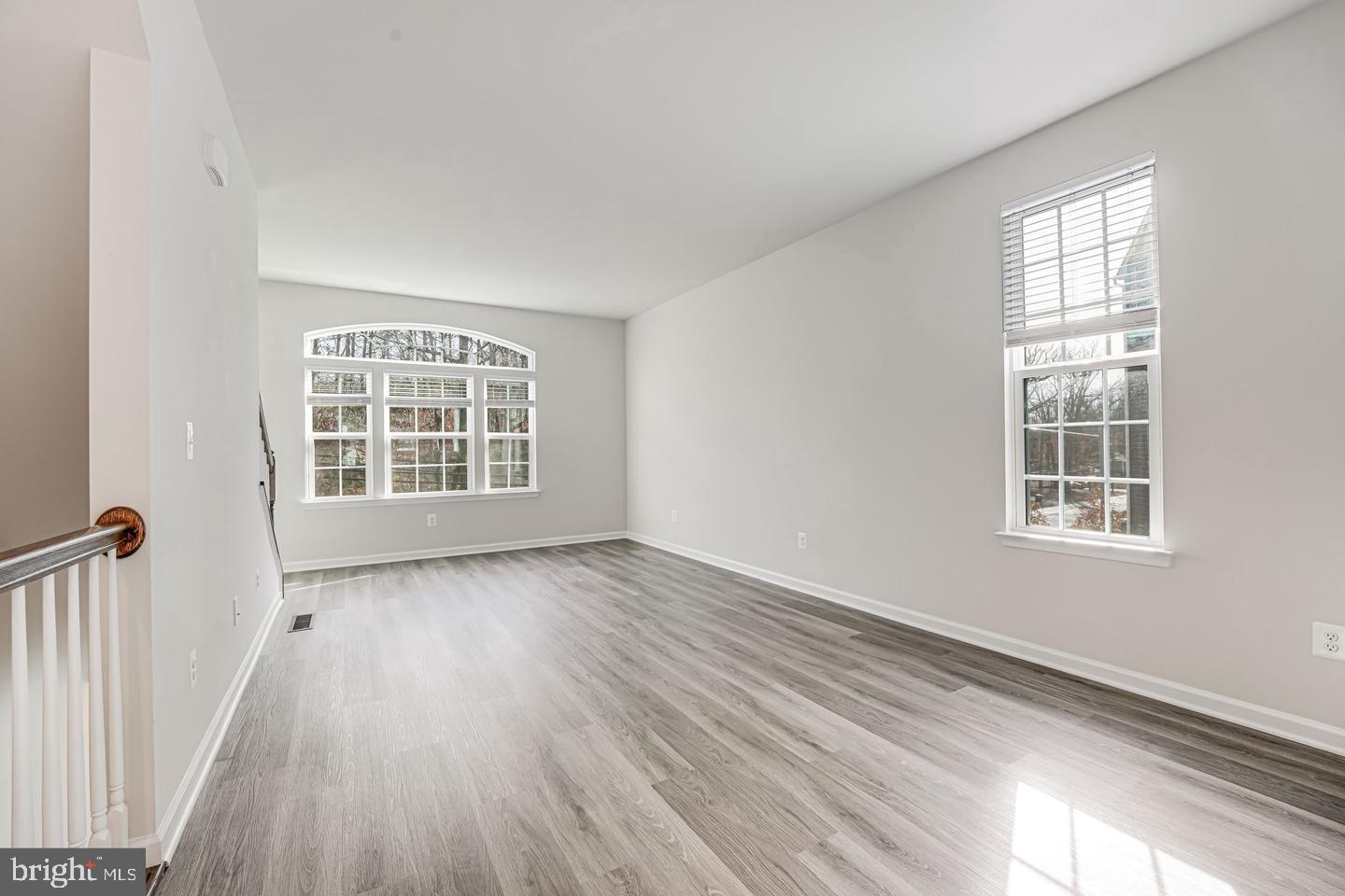 18339 Reaper Hl Court Triangle, VA 22172 - Photo 12 of 34 an empty room with wooden floor and windows