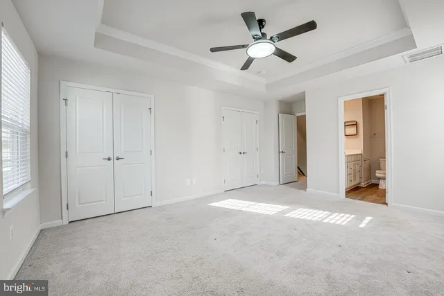 a view of empty room with ceiling fan