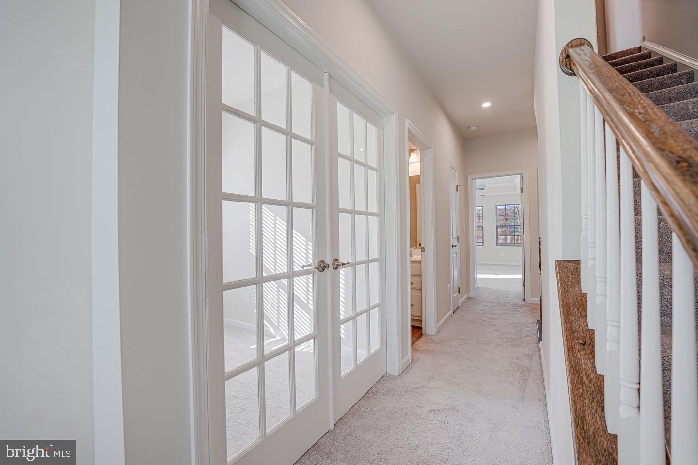 18339 Reaper Hl Court Triangle, VA 22172 - Photo 25 of 34 a view of a hallway with wooden floor and bathroom