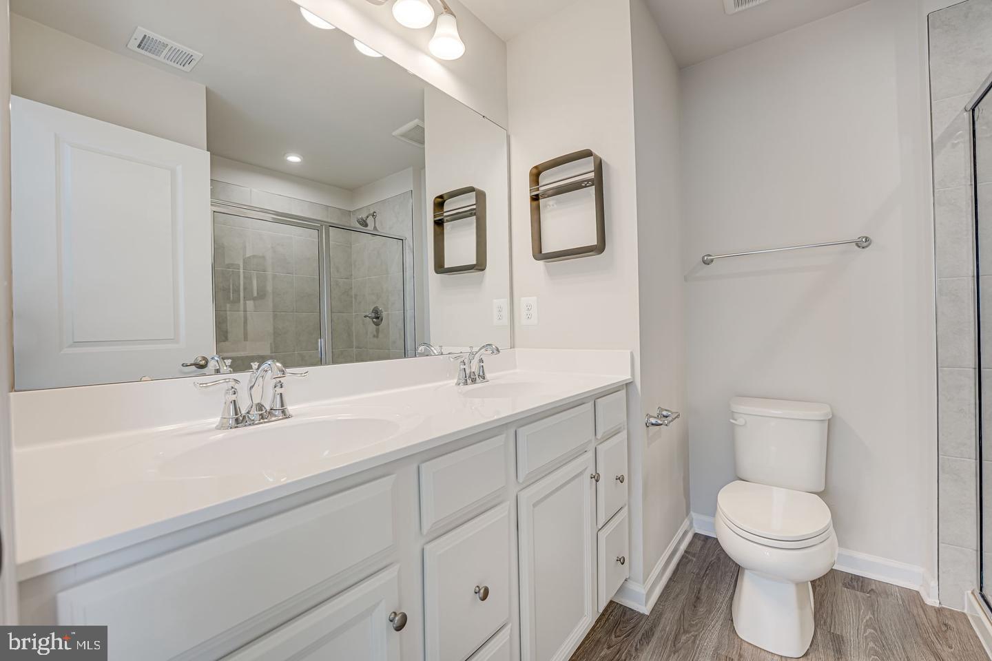 18339 Reaper Hl Court Triangle, VA 22172 - Photo 26 of 34 a bathroom with a toilet a sink a mirror and vanity