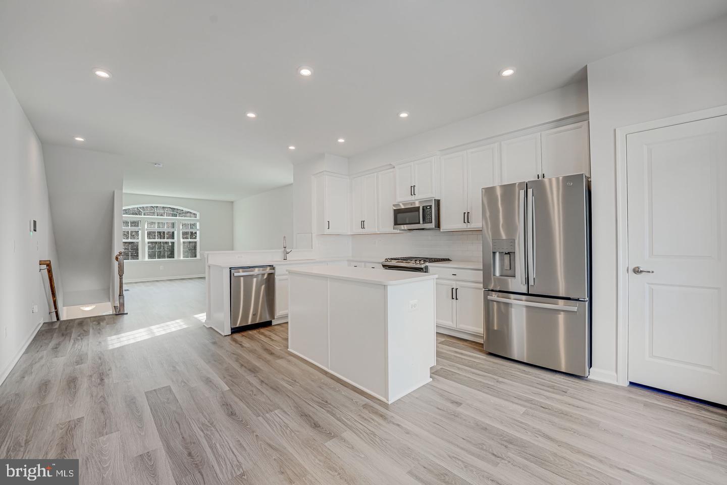 18339 Reaper Hl Court Triangle, VA 22172 - Photo 31 of 34 a kitchen with a refrigerator and a stove top oven