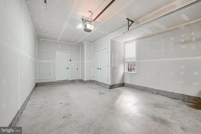 an empty room with staircase and white walls