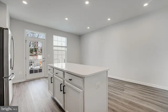 a hallway with windows and wooden floor
