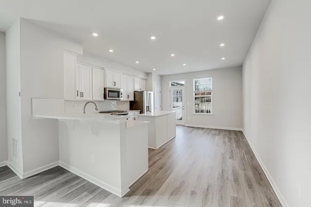 a view of kitchen with center island and stainless steel appliances
