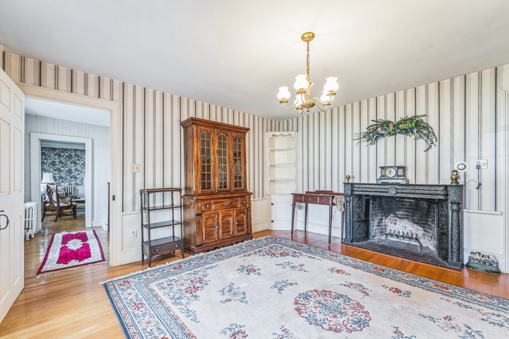 114 Summer Street Maynard, MA 01754 - Photo 11 of 32 a bedroom with furniture and a fireplace