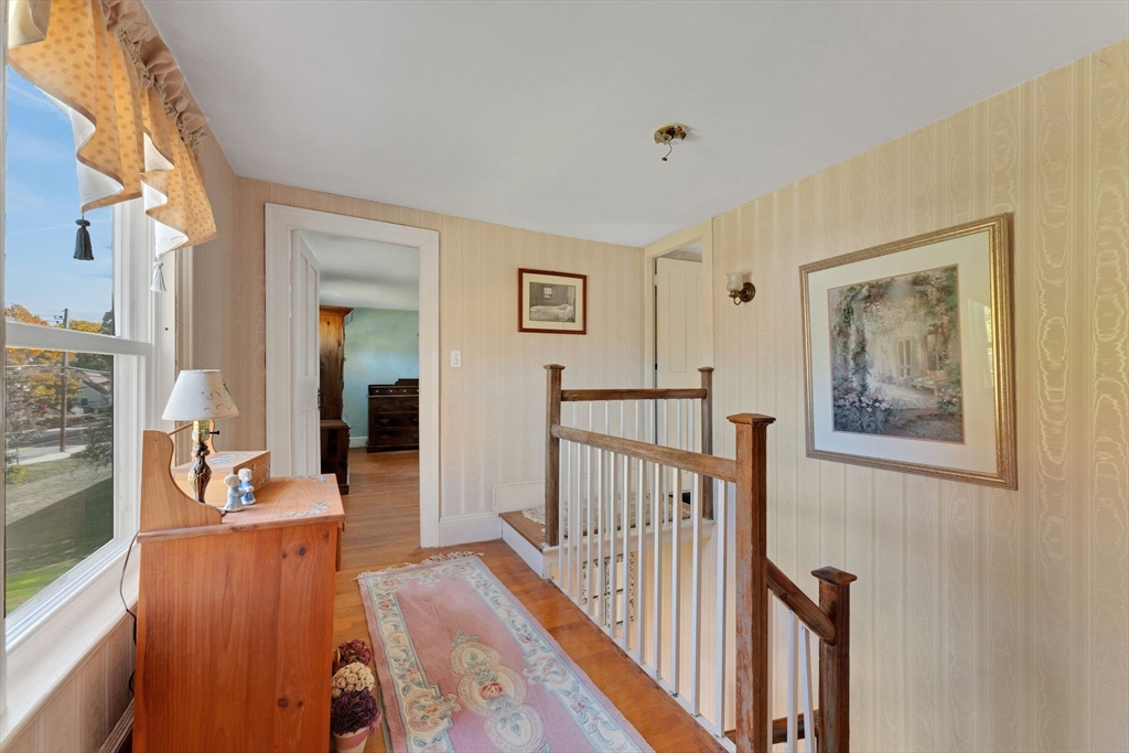 114 Summer Street Maynard, MA 01754 - Photo 2 of 32 a view of a hallway to a livingroom with furniture wooden floor and windows