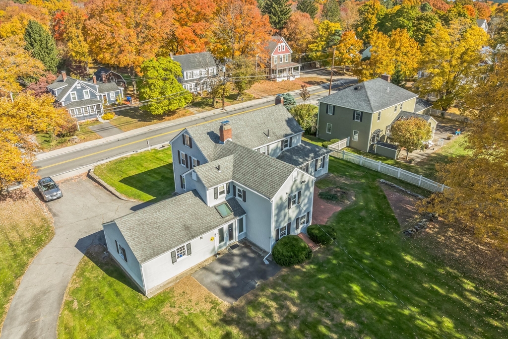 114 Summer Street Maynard, MA 01754 - Photo 25 of 32 an aerial view of a house with swimming pool and large trees