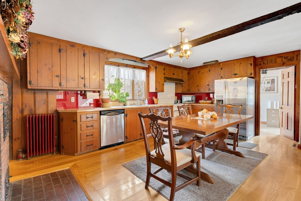 114 Summer Street Maynard, MA 01754 - Photo 4 of 32 a kitchen with stainless steel appliances kitchen island granite countertop a refrigerator a stove a sink dishwasher and a dining table with the kitchen view